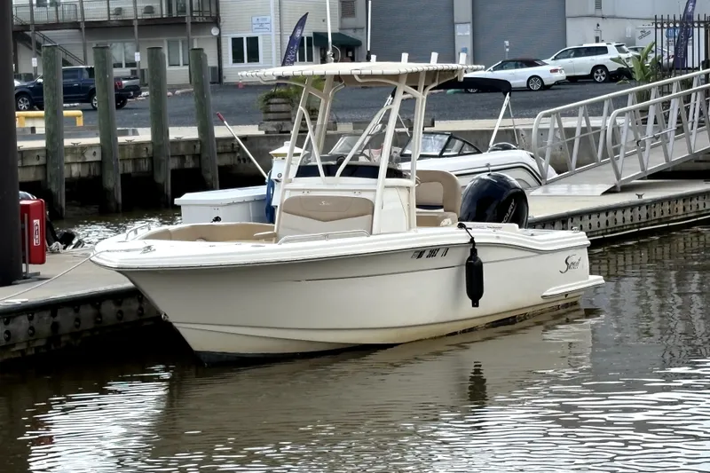 The Image of 2023 Scout 215 XSF boat docked at a marina, featuring sleek design and modern amenities. - 0