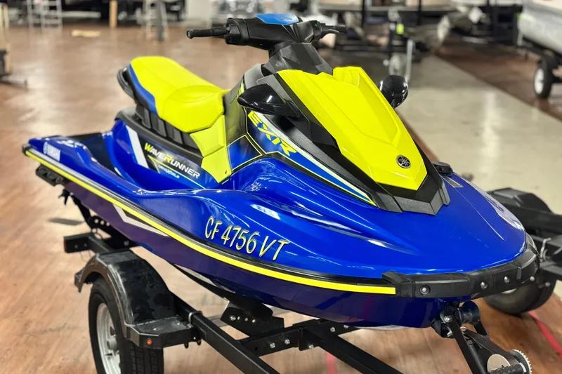 The Image of 2019 Yamaha WaveRunner EXR in blue and yellow on a trailer indoors. - 0
