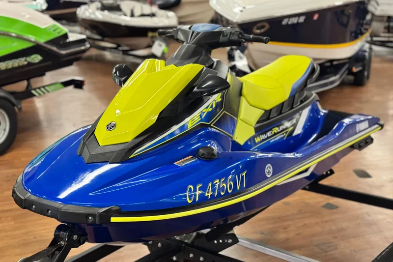 Slide: The Image of 2019 Yamaha WaveRunner EXR in vibrant blue and yellow on display indoors. - 2