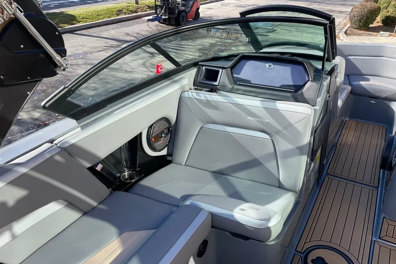 Slide: The Image of 2023 MasterCraft XStar S boat interior with sleek seating and modern dashboard design. - 10
