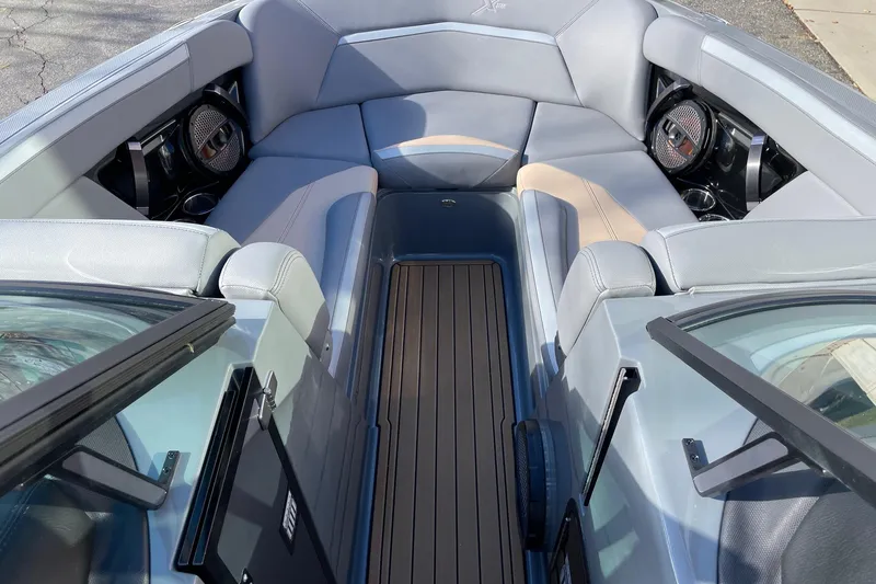 Slide: The Image of 2023 MasterCraft XStar S boat interior with luxurious seating and premium audio system. - 11