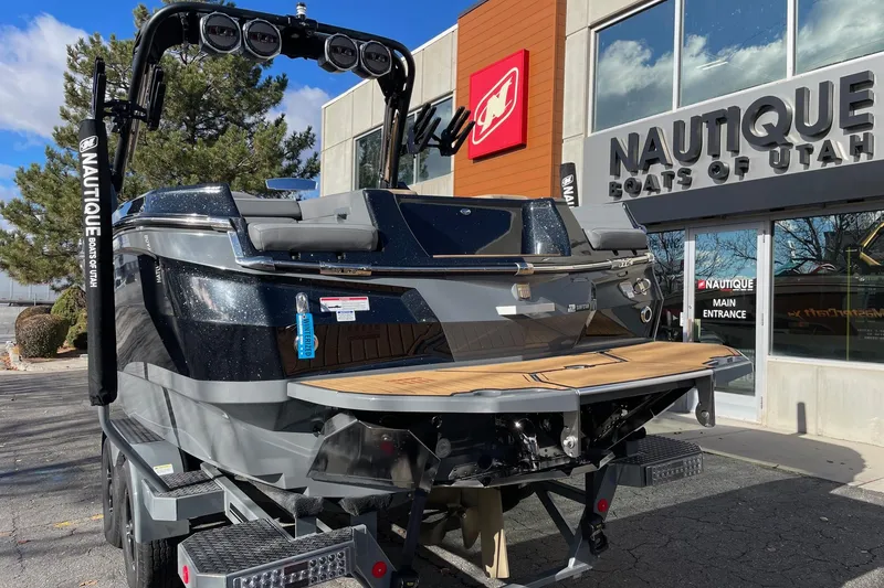 Slide: The Image of 2023 MasterCraft XStar S boat displayed outside Nautique dealership in Utah. - 3