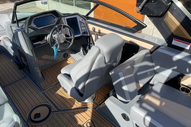 Slide: The Image of 2023 MasterCraft XStar S boat interior with sleek dashboard and luxurious seating. - 6