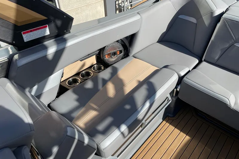 Slide: The Image of 2023 MasterCraft XStar S interior with gray seating, cup holders, and speaker. - 7