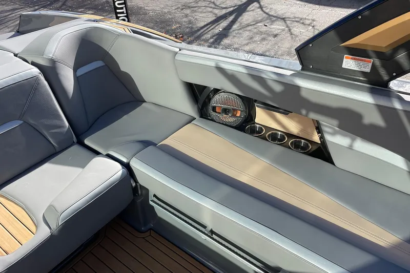 Slide: The Image of 2023 MasterCraft XStar S interior with gray seating and integrated speaker system. - 9