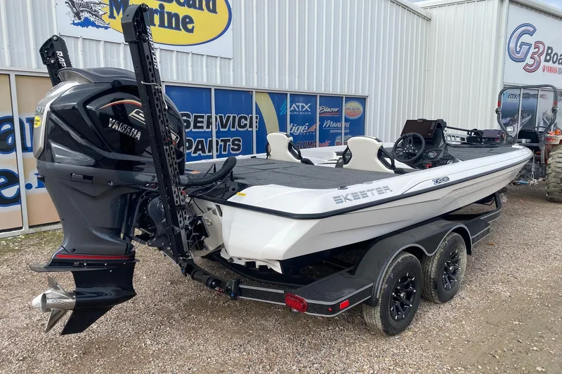 Slide: The Image of 2026 Skeeter ZXE21 boat with Yamaha engine on a trailer outside a marine shop. - 5