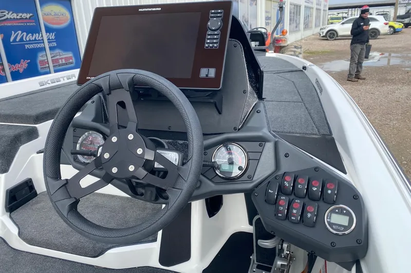 Slide: The Image of 2026 Skeeter ZXE21 boat dashboard with steering wheel and control panel. - 6
