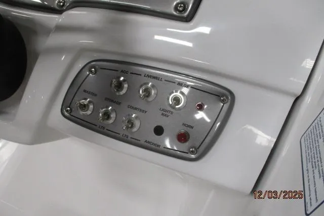 Slide: The Image of Control panel of a 2025 Tahoe 1950 boat with various switches and buttons. - 2