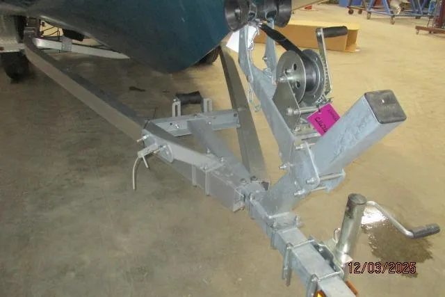 Slide: The Image of Trailer hitch of a 2025 Tahoe 1950 boat, indoors, with visible winch and date stamp. - 6