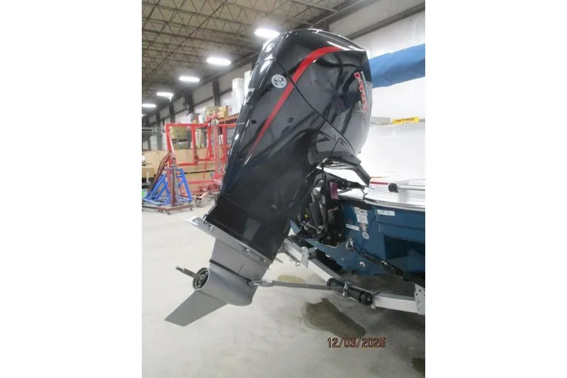 Slide: The Image of Outboard motor on a Tahoe 1950 boat, 2025 model, in a warehouse setting. - 8