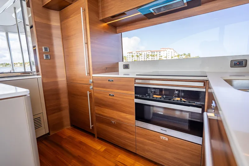 Slide: The Image of Luxurious kitchen interior on 2023 Princess Y72 yacht with modern appliances and wood finish. - 19