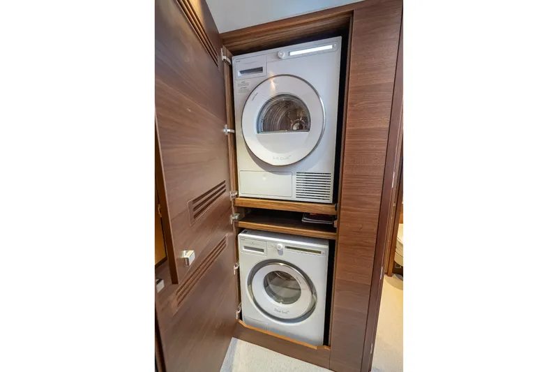 Slide: The Image of Stacked washer and dryer in 2023 Princess Y72 yacht's wooden cabinet. - 35