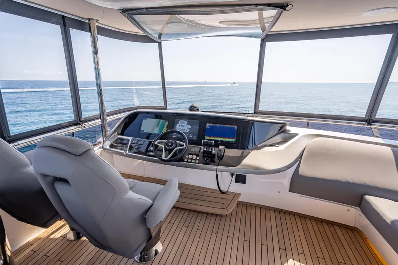 Slide: The Image of Helm of 2023 Princess Y72 yacht with ocean view, featuring modern navigation equipment. - 41