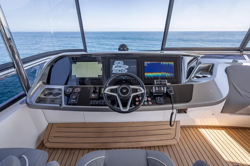 Slide: The Image of Helm of 2023 Princess Y72 yacht with advanced navigation displays and ocean view. - 43
