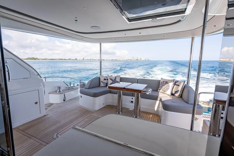 Slide: The Image of Luxurious 2023 Princess Y72 yacht interior with ocean view and elegant seating area. - 9