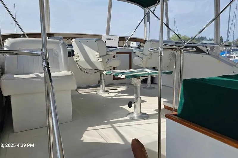 Slide: The Image of 1988 Canoe Cove Tri-Cabin yacht interior with seating and navigation equipment. - 10