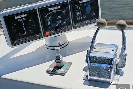 Slide: The Image of Control panel of a 1988 Canoe Cove Tri-Cabin with Simrad navigation displays. - 11