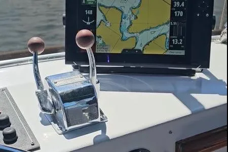 Slide: The Image of 1988 Canoe Cove Tri-Cabin control panel with navigation screen and throttle levers. - 13