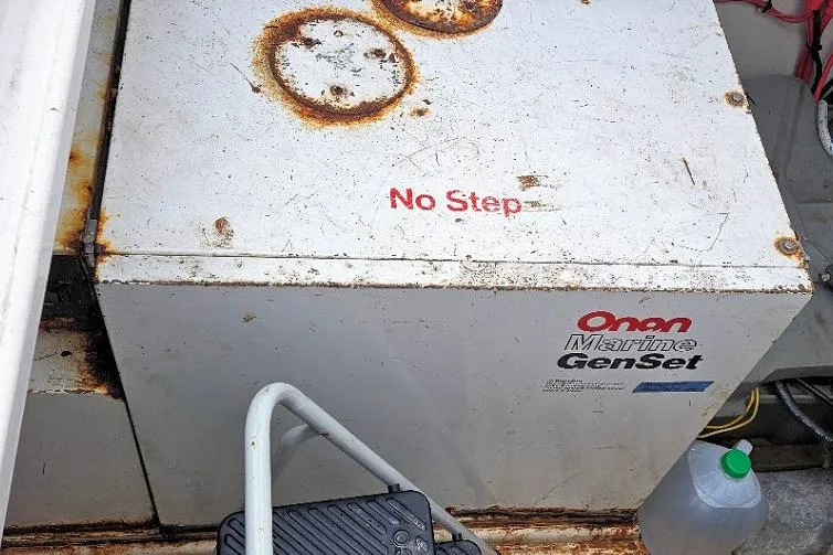 Slide: The Image of Rusty Onan Marine GenSet on 1988 Canoe Cove Tri-Cabin boat, marked "No Step." - 19