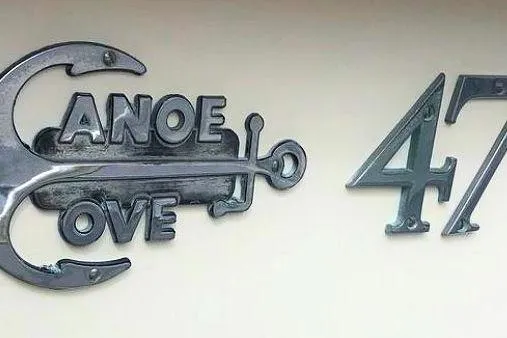 Slide: The Image of 1988 Canoe Cove Tri-Cabin 47 emblem with anchor design. - 20