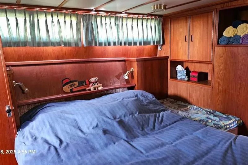 Slide: The Image of Cozy cabin interior of 1988 Canoe Cove Tri-Cabin with bed and wooden furnishings. - 6