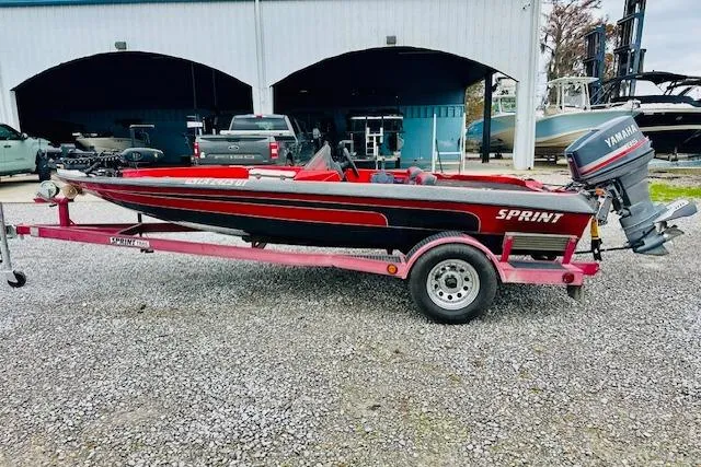 The Image of Red and black 1997 Sprint 267 boat on trailer with Yamaha outboard motor. - 0