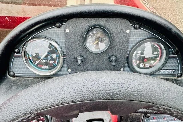 Slide: The Image of Dashboard of a 1997 Sprint 267 boat with speedometer and gauges. - 11