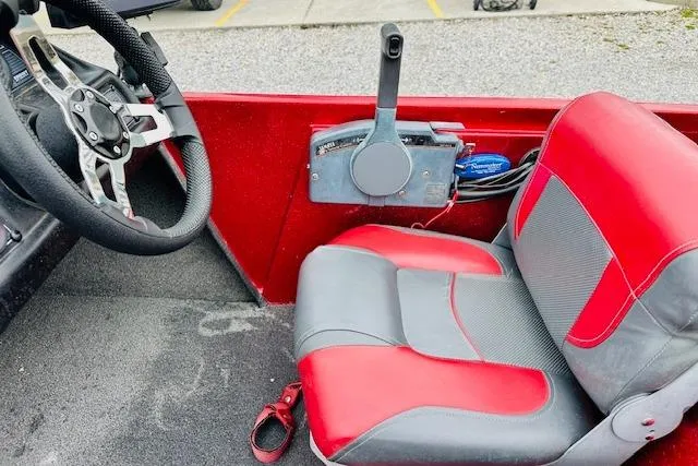 Slide: The Image of Interior of a 1997 Sprint 267 boat with red and gray seating. - 12