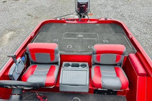 Slide: The Image of Red and gray interior of a 1997 Sprint 267 boat with dual seats and console. - 13