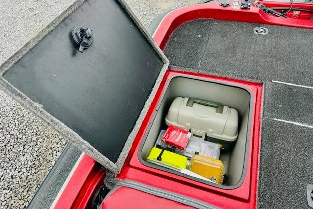 Slide: The Image of Open storage compartment in a 1997 Sprint 267 boat, containing various gear and equipment. - 16