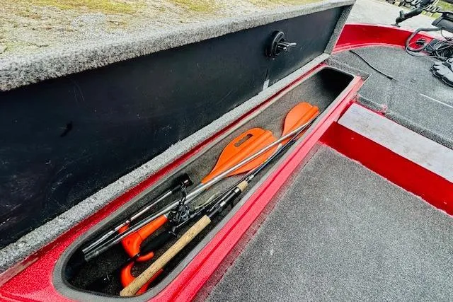 Slide: The Image of Storage compartment in a 1997 Sprint 267 boat with fishing rods and orange paddles. - 20