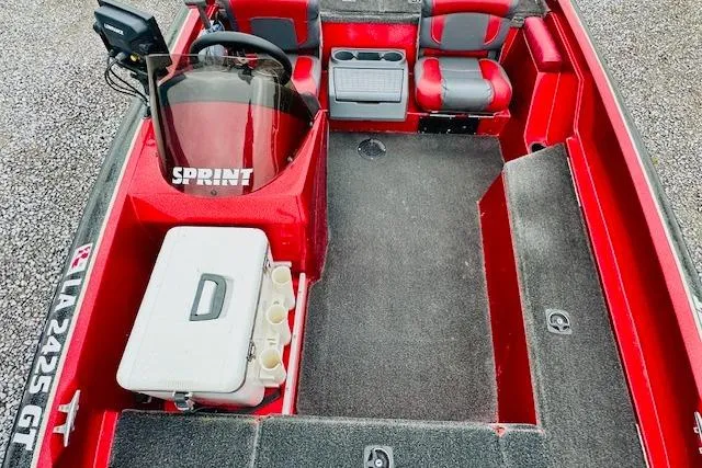 Slide: The Image of Red and gray interior of a 1997 Sprint 267 boat with seating and storage. - 22
