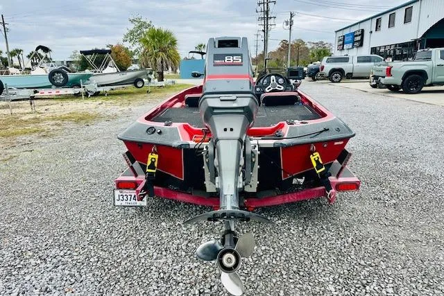 Slide: The Image of 1997 Sprint 267 boat with outboard motor in a gravel lot. - 3