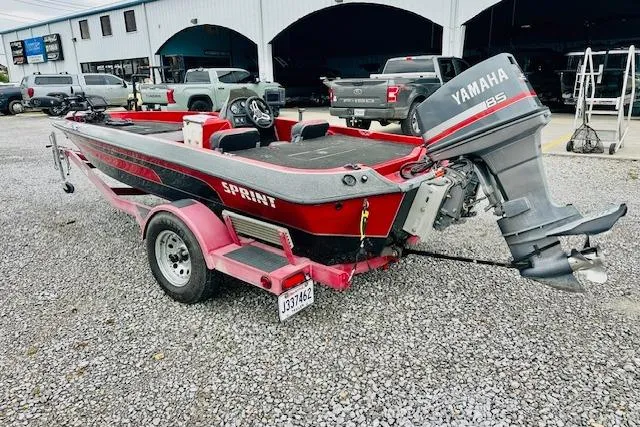 Slide: The Image of Red 1997 Sprint 267 boat with Yamaha 135 outboard motor on a trailer. - 5