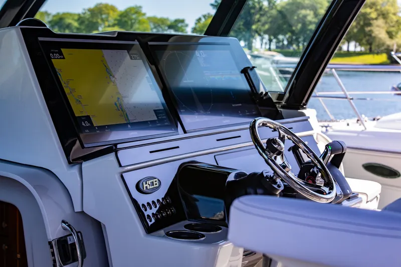 Slide: The Image of The cockpit of the 2027 HCB 56 GIX features modern navigation screens and a sleek steering wheel. - 12