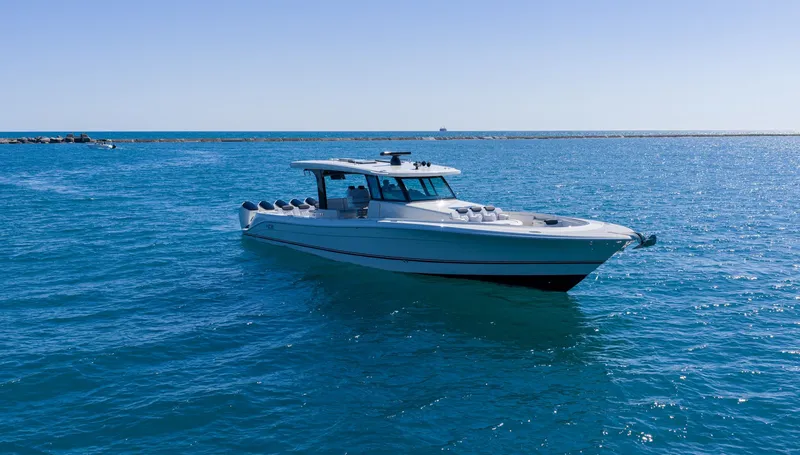 The Image of A modern boat cruising on calm, blue water. It features a sleek design and a covered cockpit. - 2