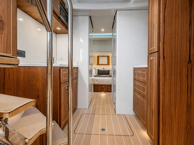 Slide: The Image of Interior of a luxury yacht with wooden floors and sleek cabinetry. - 24