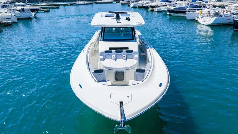 Slide: The Image of HCB 56 GIX from 2027 in a marina, sleek design, spacious deck, surrounded by other boats. - 33