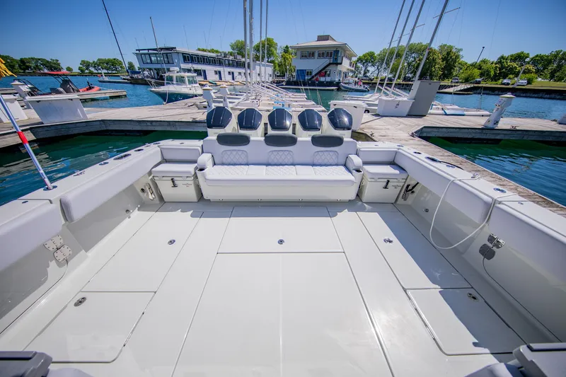 Slide: The Image of The image shows the spacious aft deck of an HCB 56 GIX docked at a marina. - 4