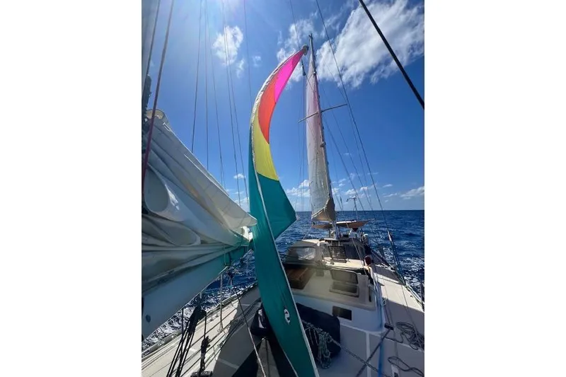 Slide: The Image of Sailing on a 1985 Robert Clark Ketch under clear blue skies. - 12