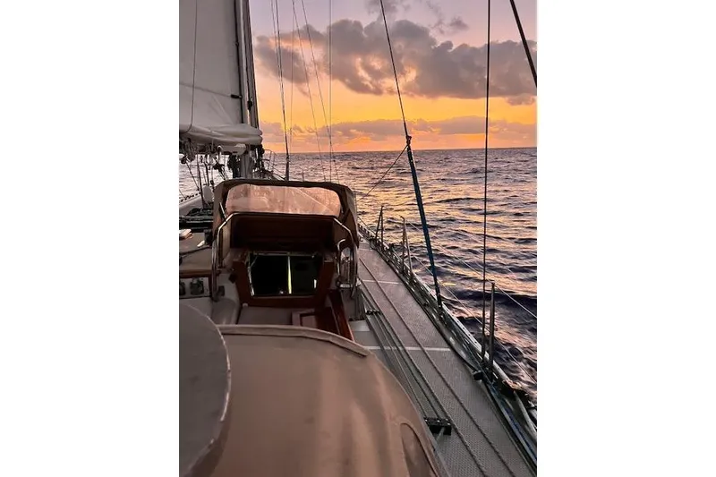 Slide: The Image of Sailing on a 1985 Robert Clark Ketch at sunset, ocean view. - 15