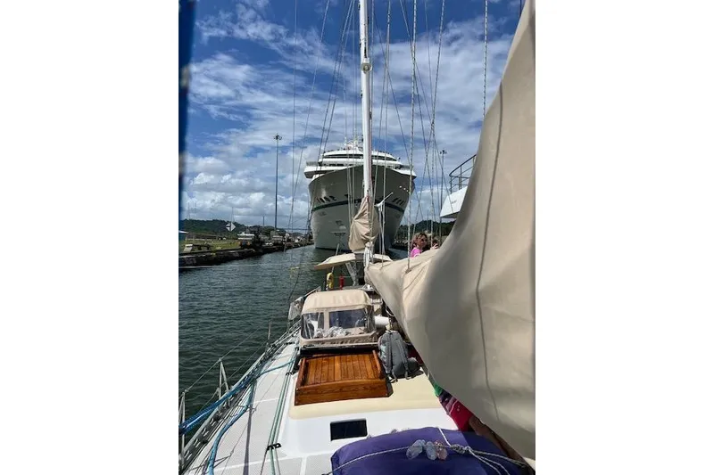 Slide: The Image of Sailing yacht "Robert Clark Ketch 1985" navigating near a large ship in a canal. - 17