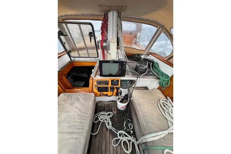 Slide: The Image of Interior of a 1985 Robert Clark Ketch sailboat with navigation equipment and ropes. - 19