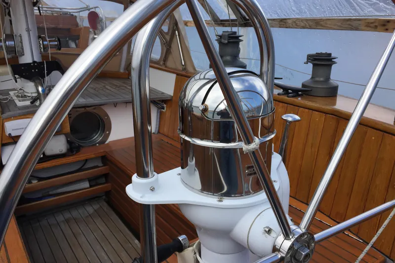 Slide: The Image of Steering wheel and compass on 1985 Robert Clark Ketch sailboat deck. - 23