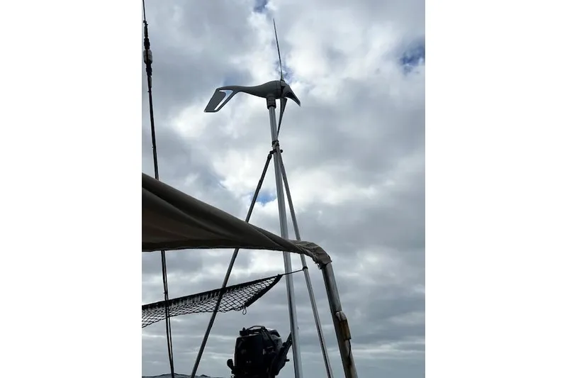 Slide: The Image of Wind turbine on 1985 Robert Clark Ketch sailboat against cloudy sky. - 29
