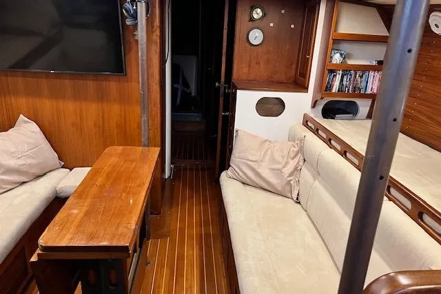 Slide: The Image of Cozy 1985 Robert Clark Ketch interior with wooden furnishings and comfortable seating. - 32