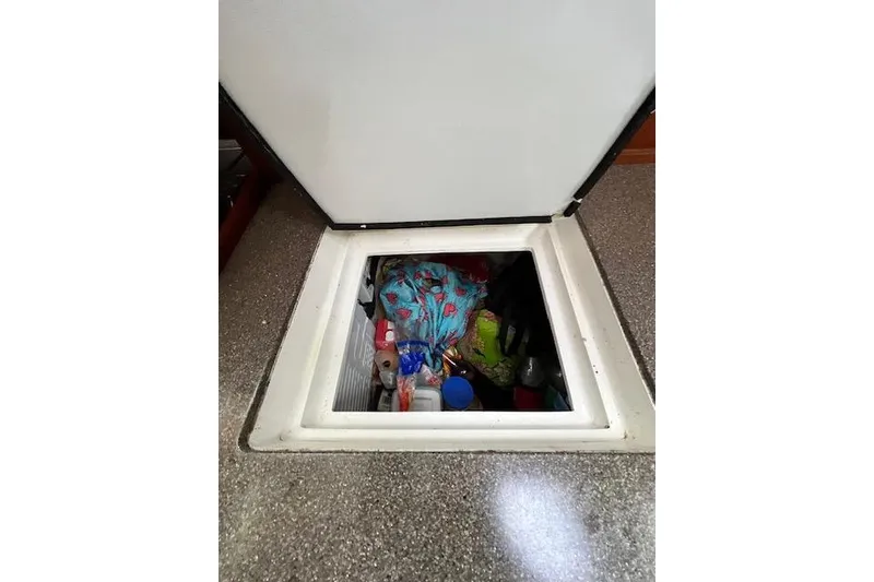 Slide: The Image of Storage compartment on 1985 Robert Clark Ketch, filled with various items and supplies. - 35