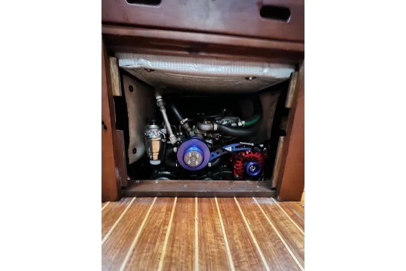 Slide: The Image of Engine compartment of a 1985 Robert Clark Ketch sailboat, featuring visible mechanical components. - 38