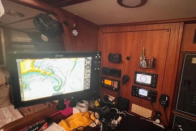 Slide: The Image of Navigation equipment and electronics inside a 1985 Robert Clark Ketch sailboat cabin. - 41