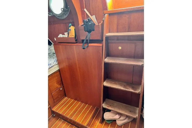 Slide: The Image of Wooden interior of 1985 Robert Clark Ketch with steps and storage. - 42
